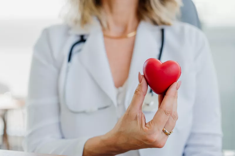 Doctor holding up a heart, representing heart care at Texas Health Hospital Mansfield