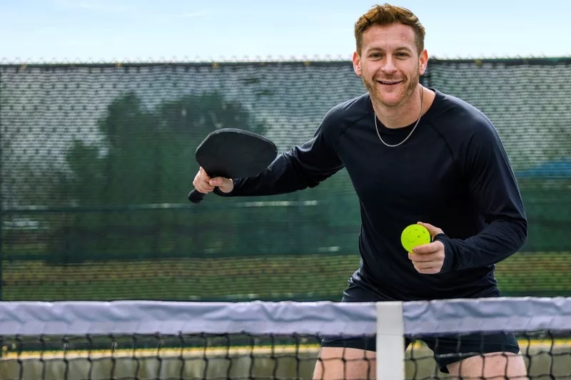 Guy playing pickleball