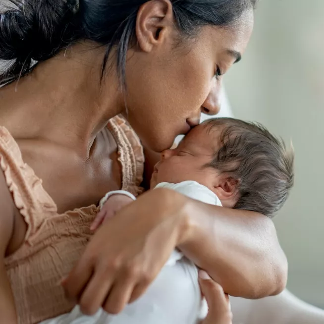 Mom kissing her baby